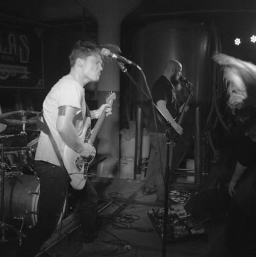 Playing guitar with the band.