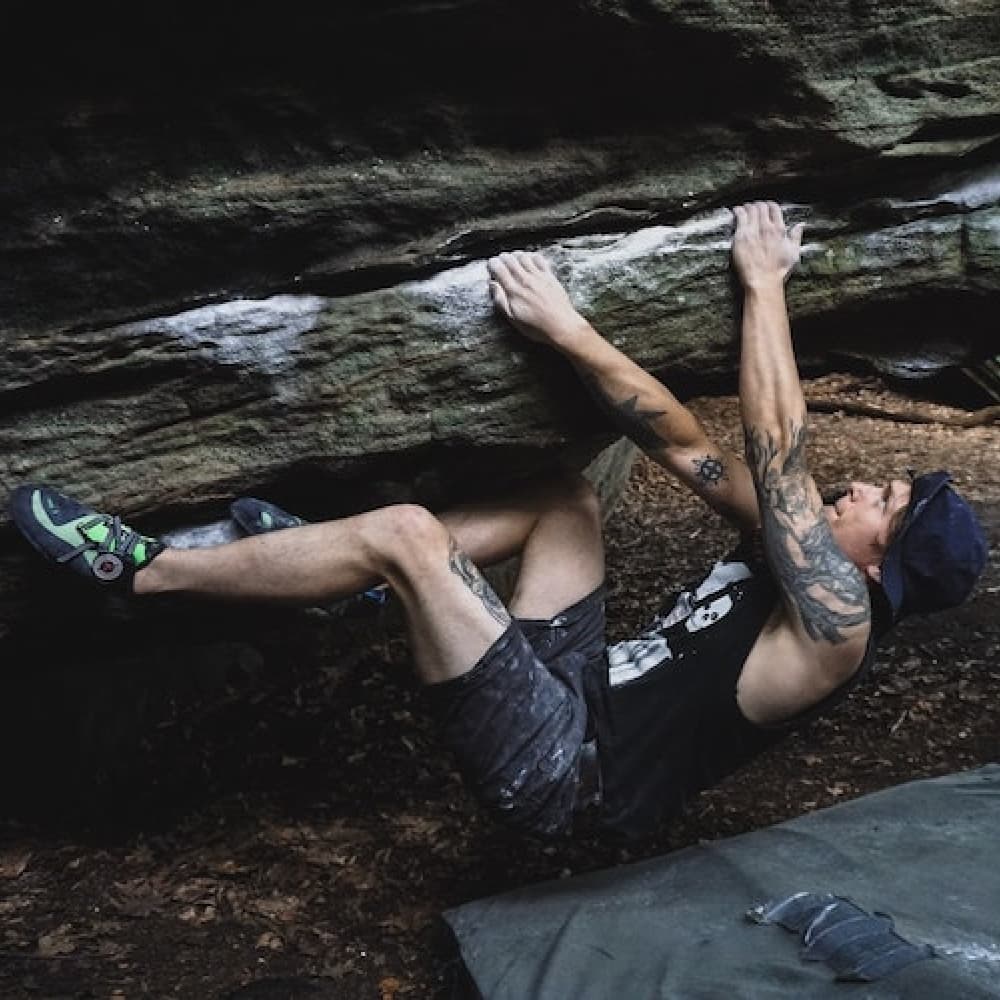 Working a bouldering problem outside.